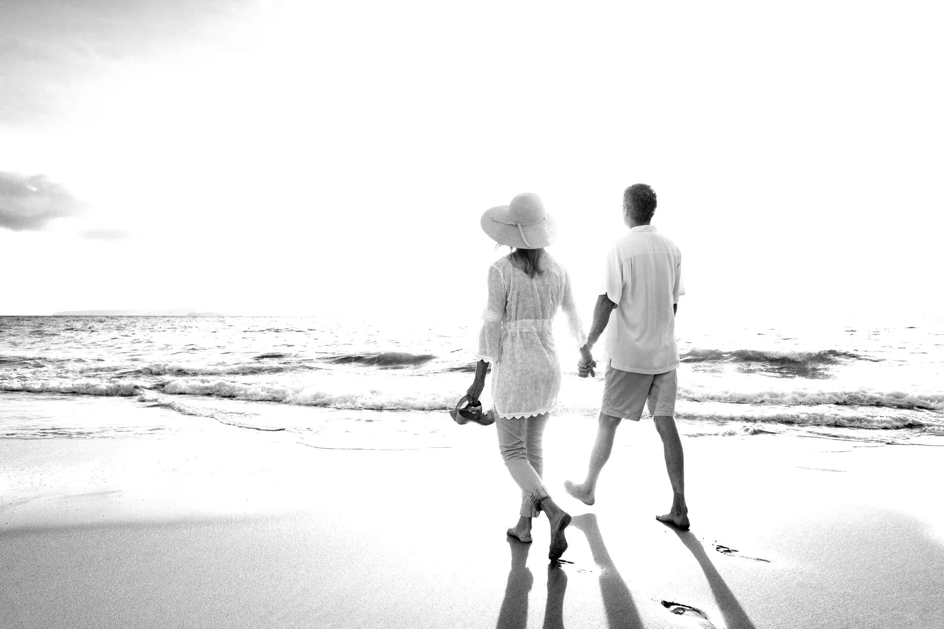 Retired couple walking on beach